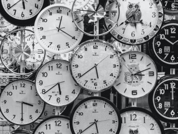 black and white photo of clocks