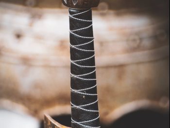 closeup photo of black hilt and brown sword