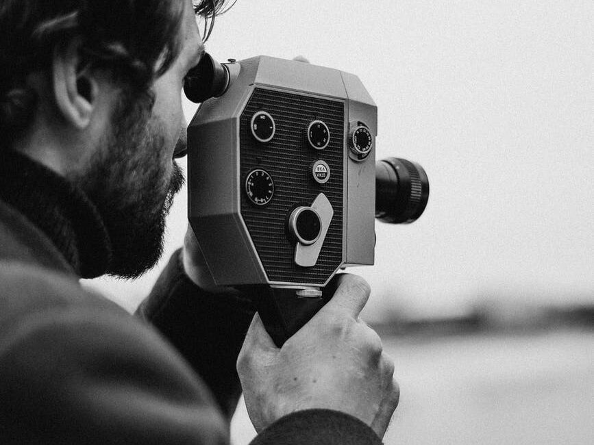 man in long sleeve capturing photo