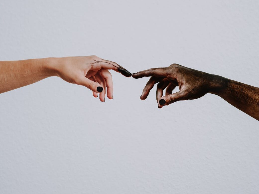hands of people reaching to each other