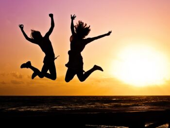 silhouette photography of jump shot of two persons